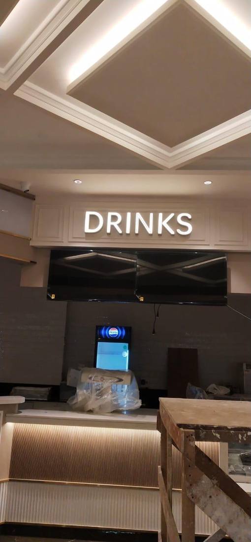 Backlit washroom directional sign